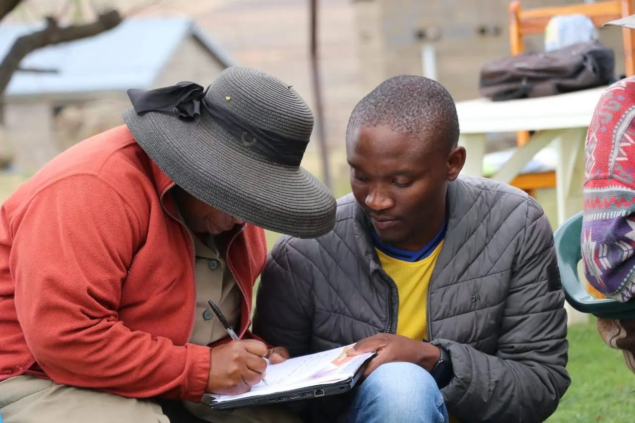 A GEM field researcher records an interview with a community elder during data collection.