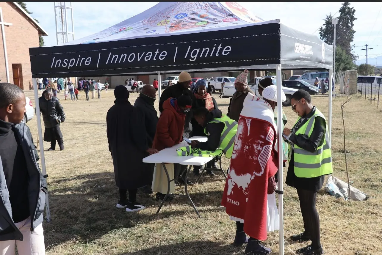 Community members register at a GEM outreach tent during a rural engagement day.